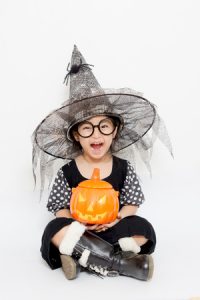 child with pumpkin in halloween